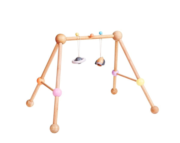 baby wooden play gym by plan toys in a natural wooden colour with planet and rocket ornaments