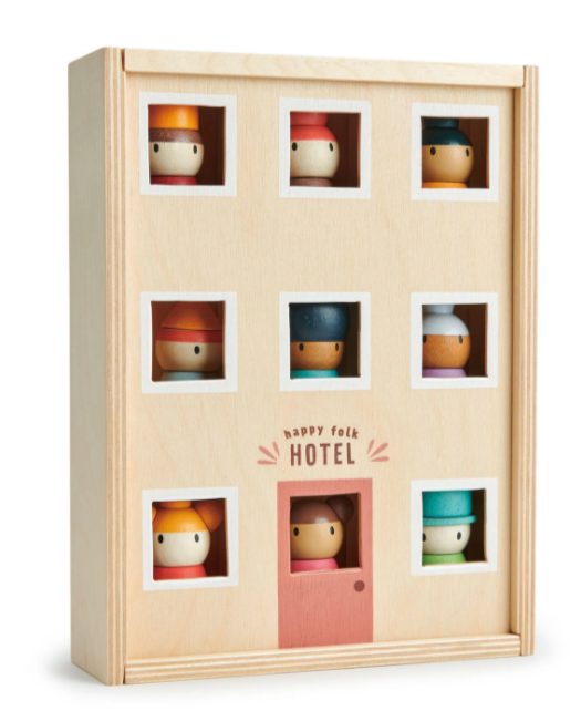 the tender leaf wooden toy hotel with little windows in the box for the characters to look out