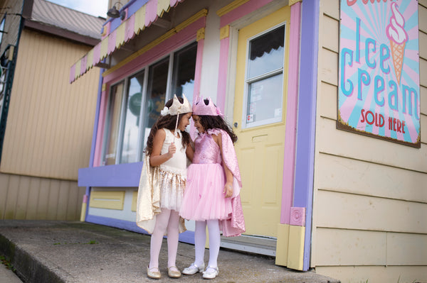 two girls in their pink glitter sequined outfits playing outside 