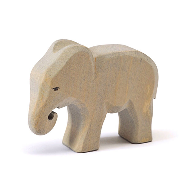 a wooden carved elephant with trunk looped down