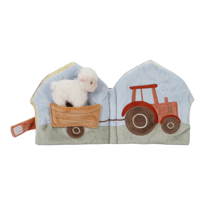 a sheep being towed by the tractor in the little dutch soft activity book