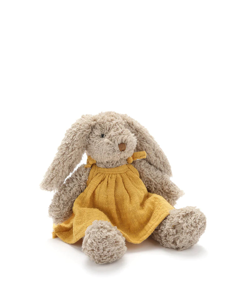 baby honey bunny soft toy with beige fur and a yellow dress