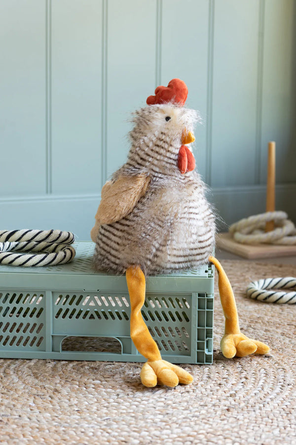 rupert rooster soft toy sitting on a blue crate