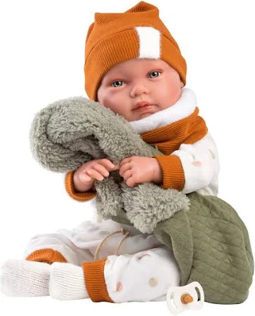 Baby in winter clothing with an orange hat and scarf on a white background