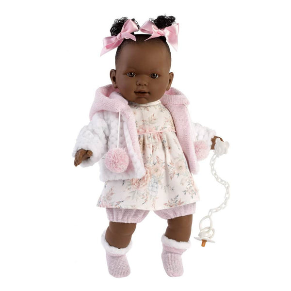 Doll wearing a pink outfit with a white background