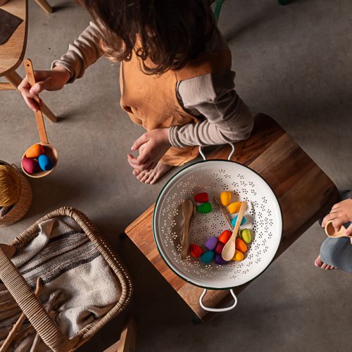 children are playing with the mandala rainbow eggs in a imaginative kitchen play setting