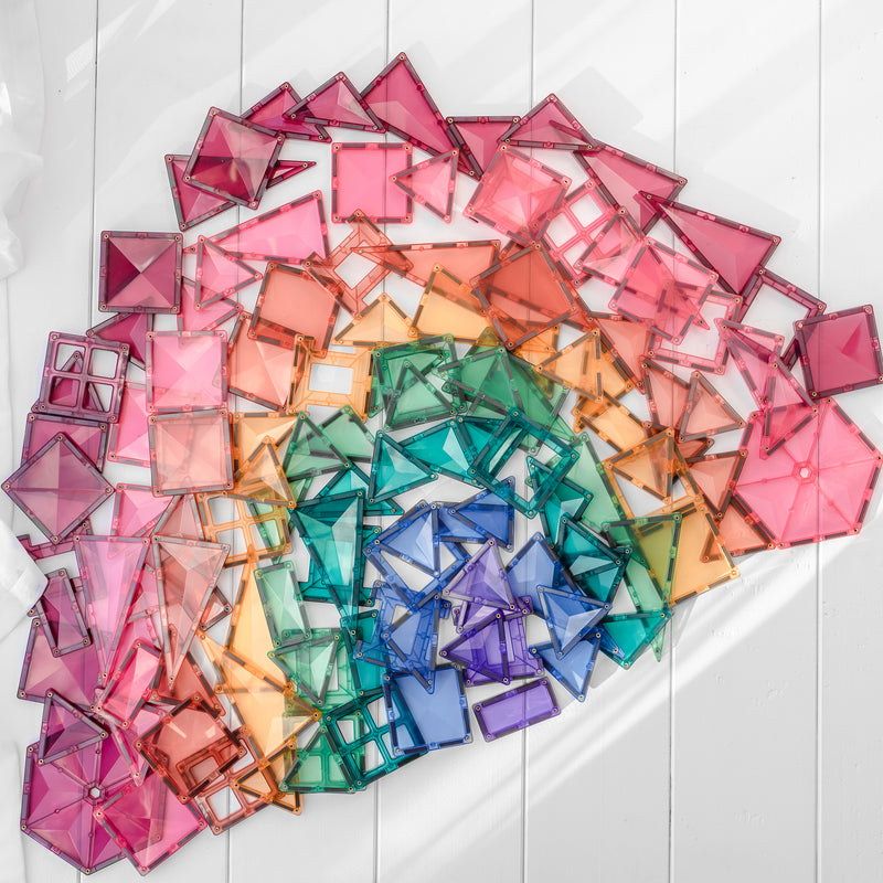 a set of magnetic tiles laid out on the ground in an amazing rainbow shape