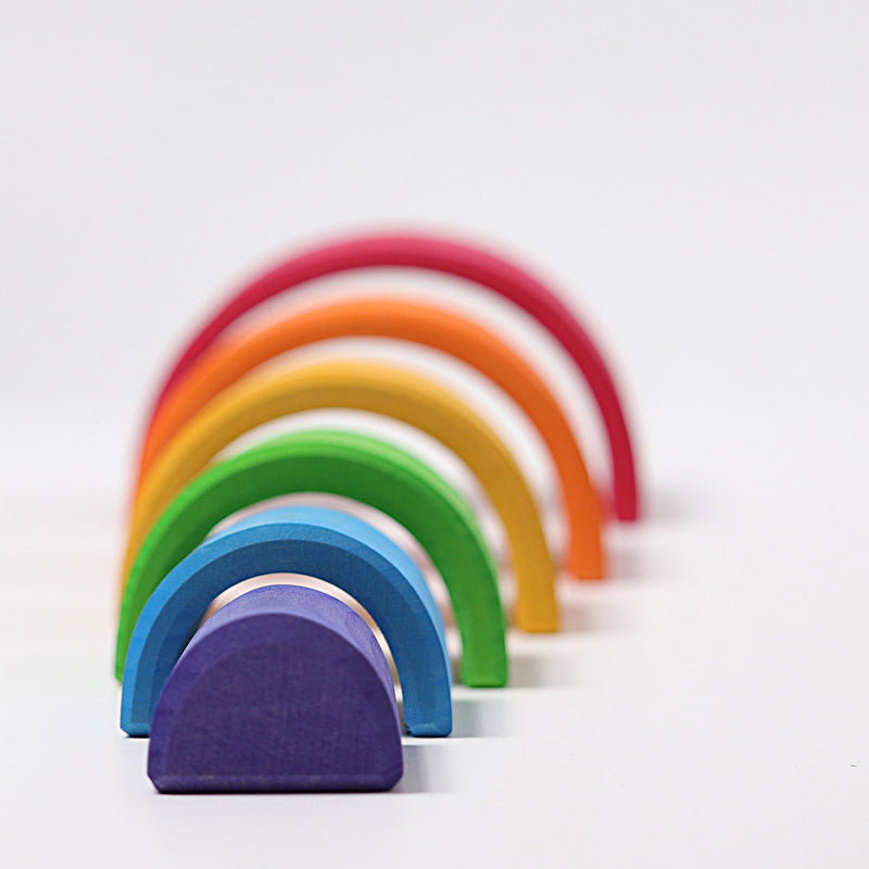 the grimms rainbow in medium stacking one by one behind each other