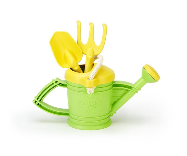 a green watering can from green toys with yellow spade and fork