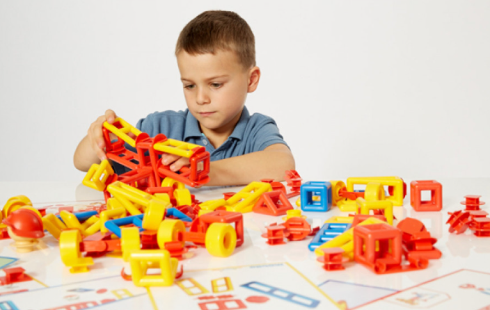 young boy playing with mobilo construction stem toys 