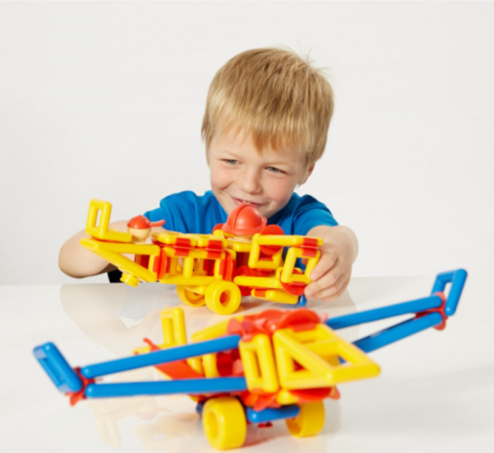 Young boy playing with stem toys mobilo creating planes