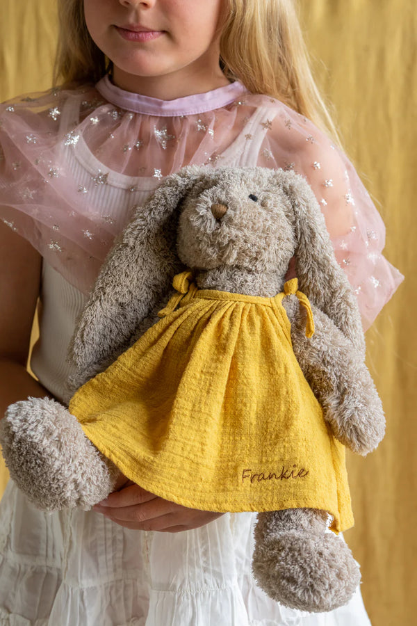 a girl holds her honey bunny soft toy in her arms