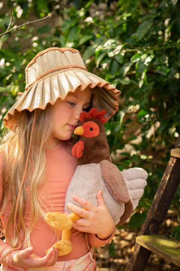 a child snuggles her nana huchy rooster outside