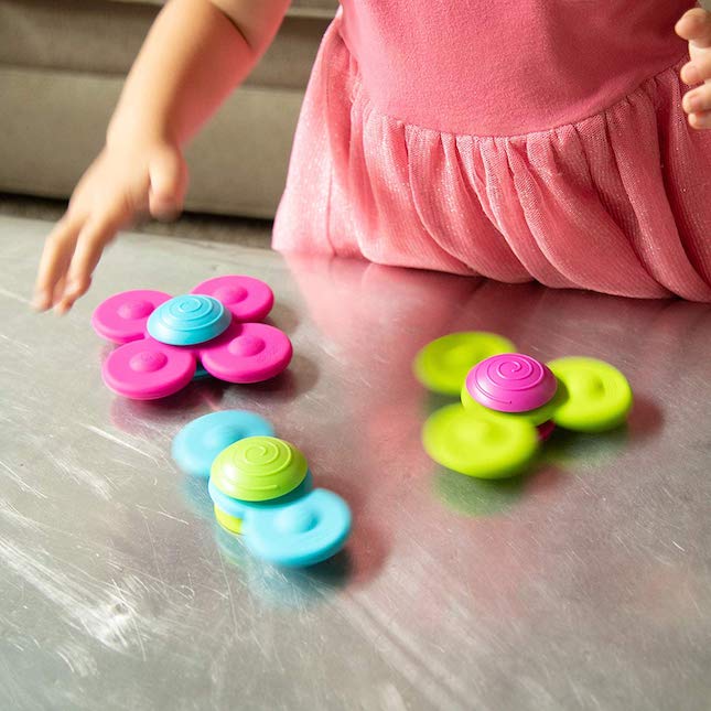 fat brain toys whirly squigz is a whirly swirling delight for children as they watch the petals spin around suctioned to the surface. Colorful, sensory and visually stimulating for children ages 2 + 
