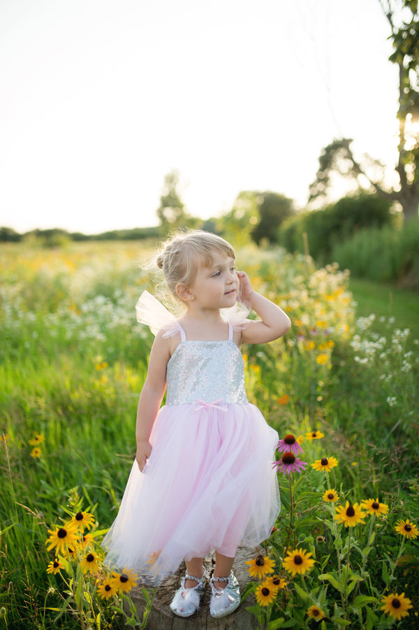 a girl wears the pink and silver girls tutu dress by great pretenders