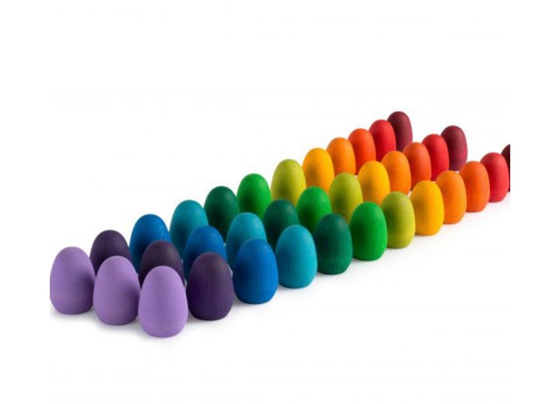 the collection on 36 rainbow mandala eggs from childplay melbourne  lined up in colour order on a plain white background