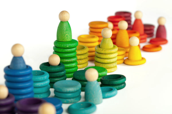 An image of the beautiful rainbow coloured wooden people and rings to collectively play and learn. Recommended age 18 months+