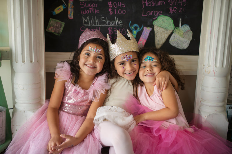 girls playihng in their great pretenders sequined butterfly and princess costumes