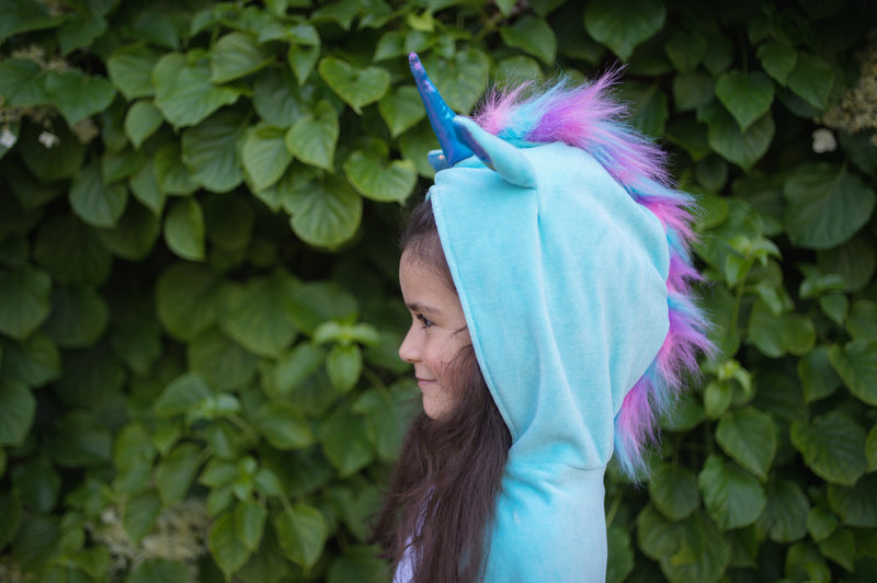 a girl faces the side it shows the unicorn costumes fluffy texture and main and shiny blue horn