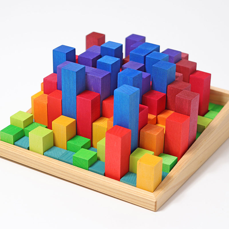 the grimms rainbow step pyramid blocks are mixed up in the tray showing different proportions of block sizes