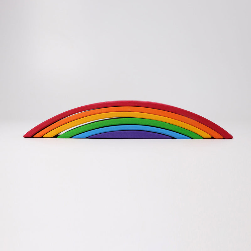 six rainbow pieces stacked on top of each other by grimms wooden toys australia