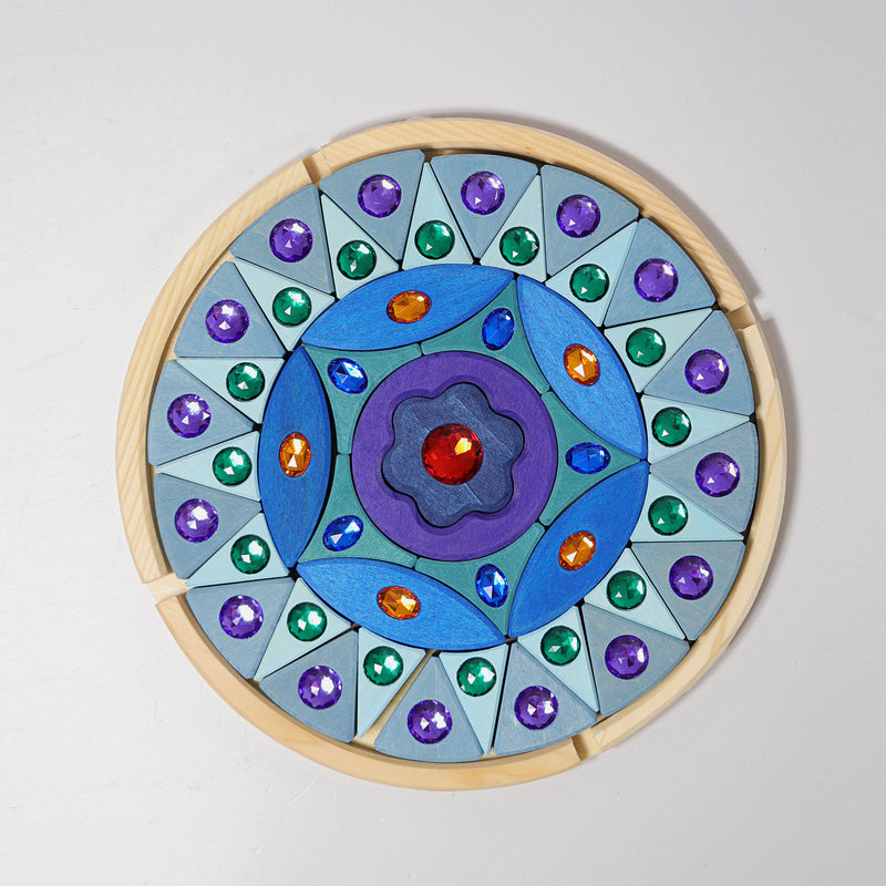 the grimms sparkling mandala with wooden puzzle blocks in blues and purples adorned with jewels