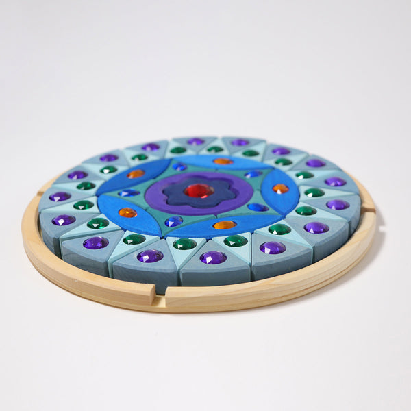the grimms wooden small sparkling mandala puzzle in its natural wood tray ready for play