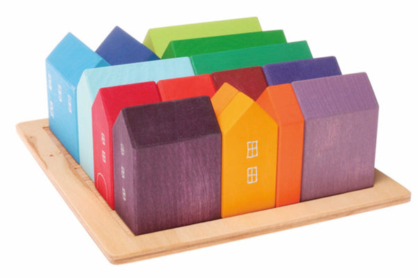 Wooden multicolour houses stacked in wooden tray. Beautifully designed by Grimms 