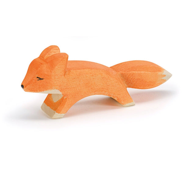 a small hand carved wooden fox with an orange colour by ostheimer wooden toys