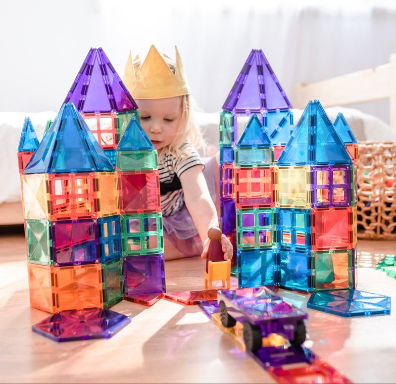 a child builds two large castles with the connetix tiles magnetic 212 piece set 
