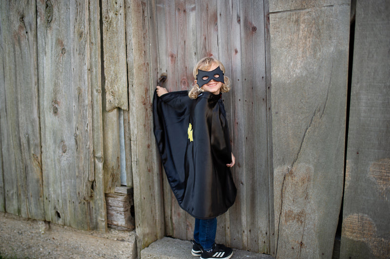 a kids wears the batman spiderman cape costume with matching mask