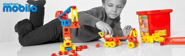 young boy playing with stem toys building construction mobilo
