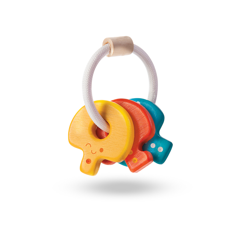 wooden baby rattle by plan toys shaped like a key chain with three wooden keys attached 