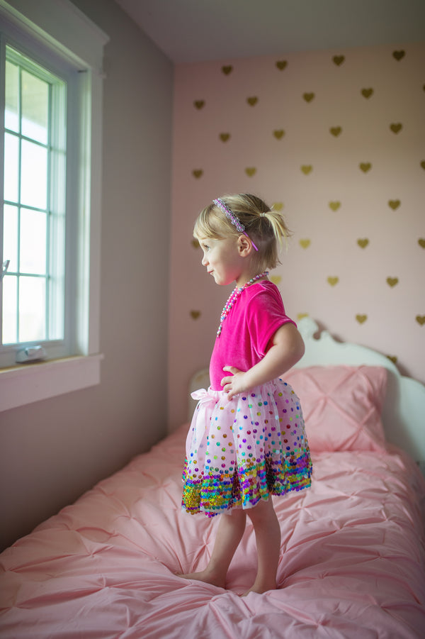 a girl wears the great pretenders sequin tulle skirt with a pink tshirt