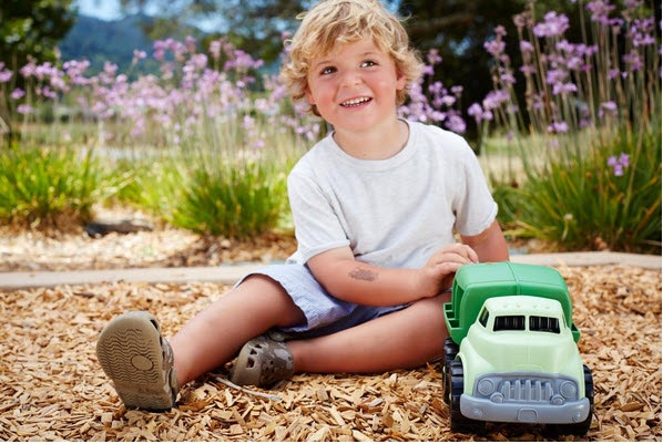 a child plays with the green toys recycling truck 